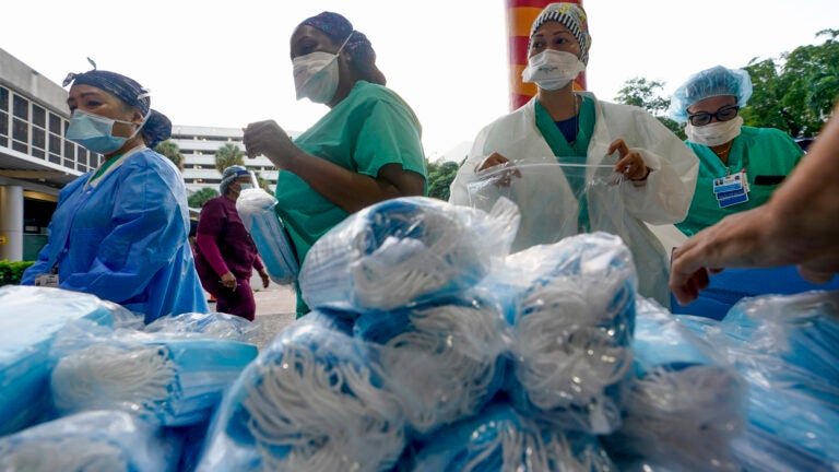 Healthcare workers line up for free personal protective equipment in Miami.