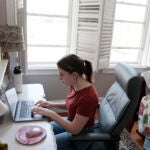 Hayley Kalukin, 22, a web designer for Boston Medical Center works from her home office inside her bedroom.