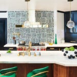 Kitchen with blue-green cabinets, and unique backsplash.